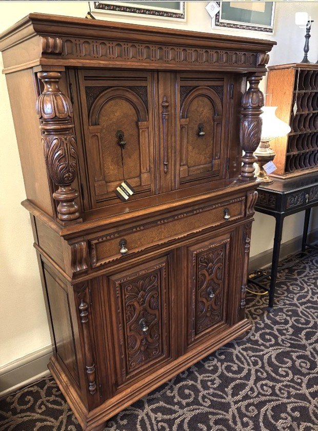 Carved Renaissance Revival oak court cupboard with turned columns.